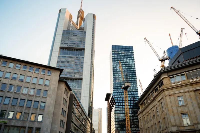 Tower cranes above city office buildings