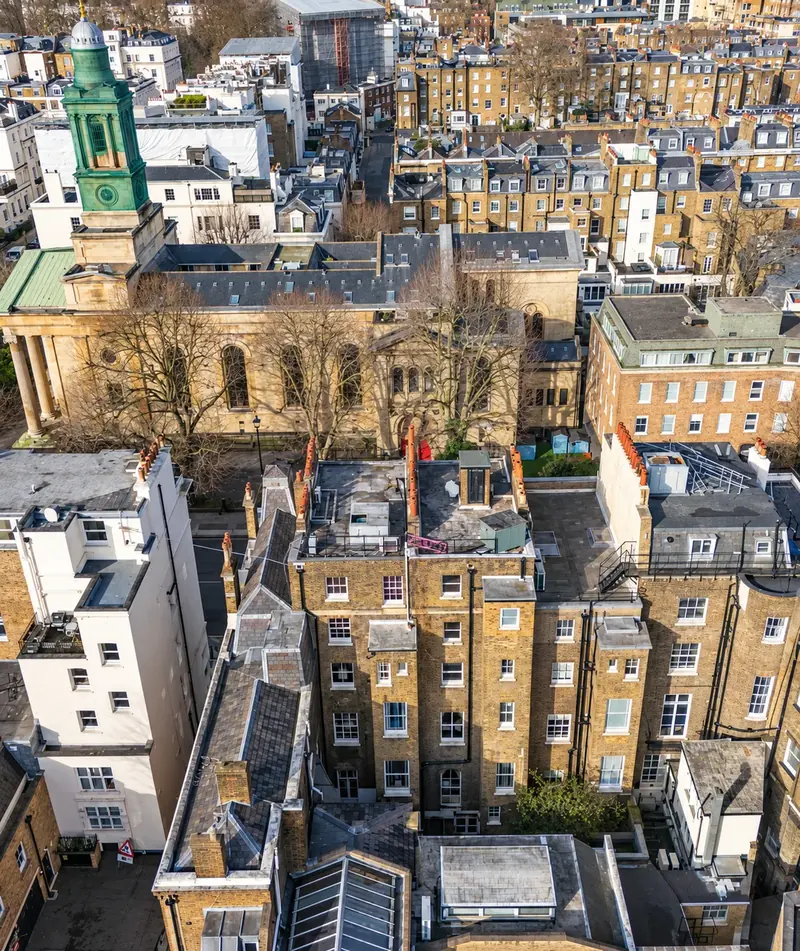 Aerial view of Belgravia rear elevations and a church tower, London