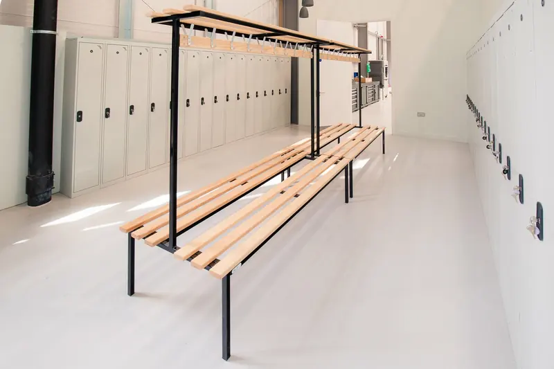 Changing room with lockers and a timber bench