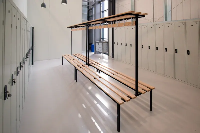 Changing room with lockers and a timber bench in a finished fit-out