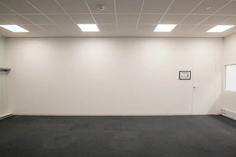 Empty finished office room with ceiling grid lighting