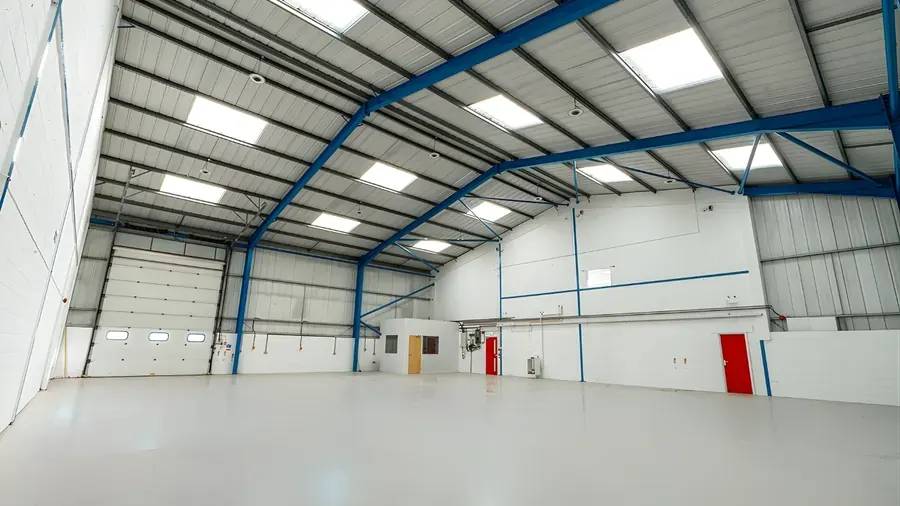 Empty steel-portal warehouse unit with roller doors