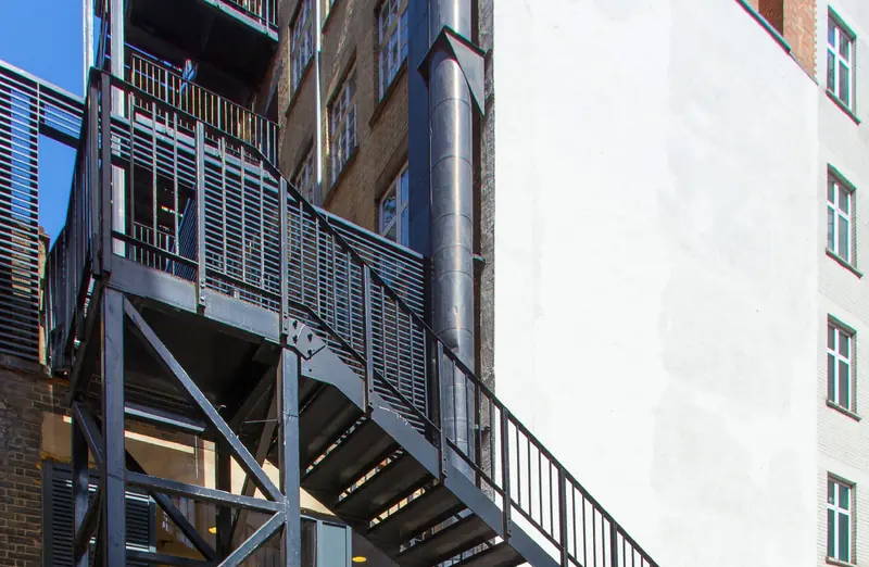 External steel staircase on a white building