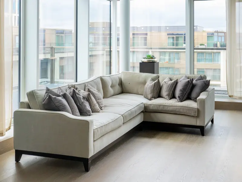 Living room with corner sofa and floor-to-ceiling windows