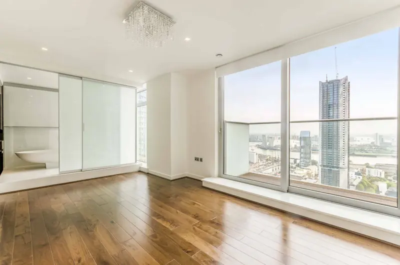 Finished living room with walnut floor and tower views