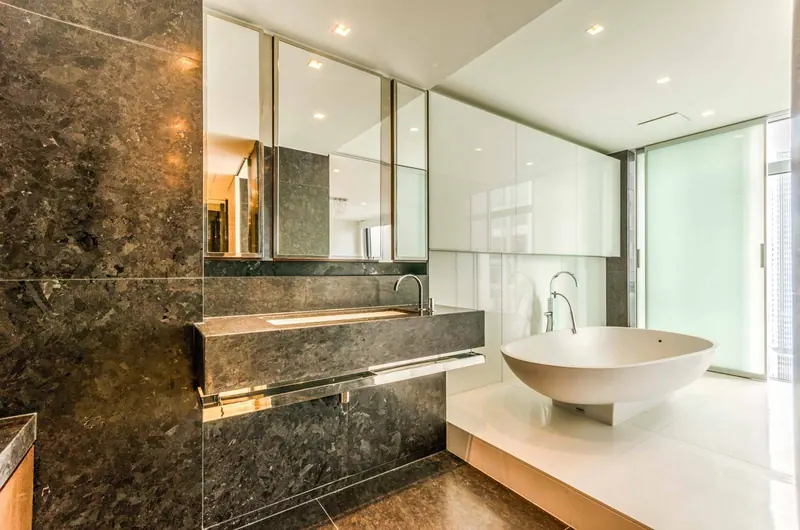 Finished marble bathroom with a freestanding bath