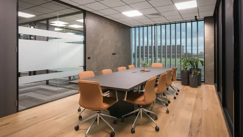 Meeting room with a long table and orange chairs