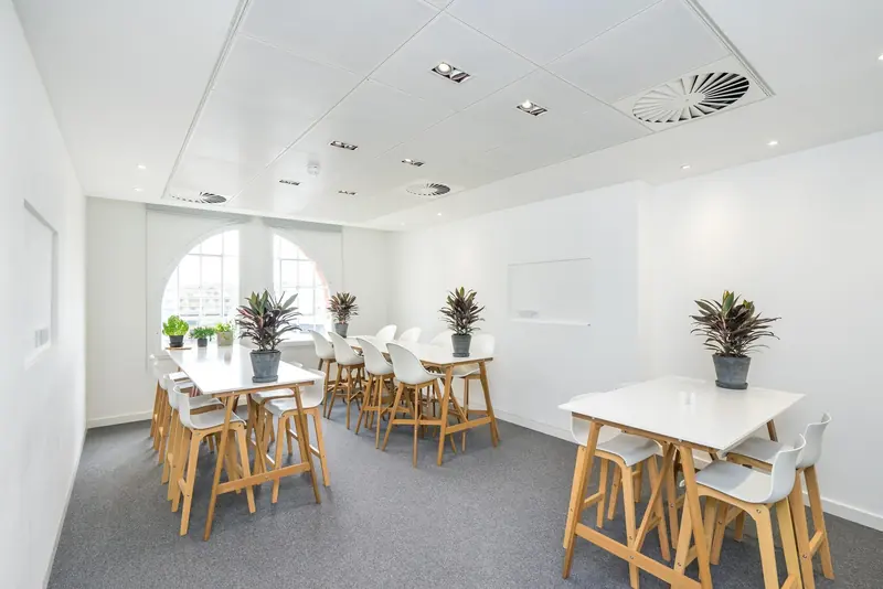 Office canteen with timber tables and arched windows
