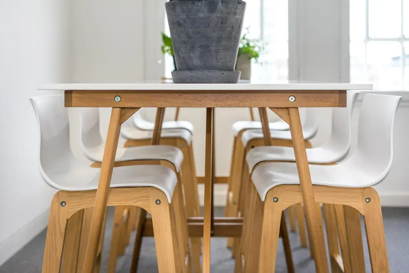 Office kitchen table with white chairs, close up