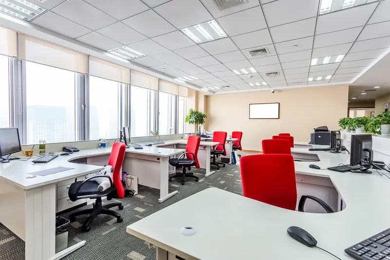 Office with red chairs and a reception desk