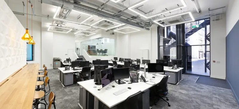 Open-plan office with black desks after a Craftex fit-out