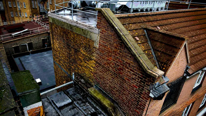 Rooftop view down into a courtyard of brick buildings