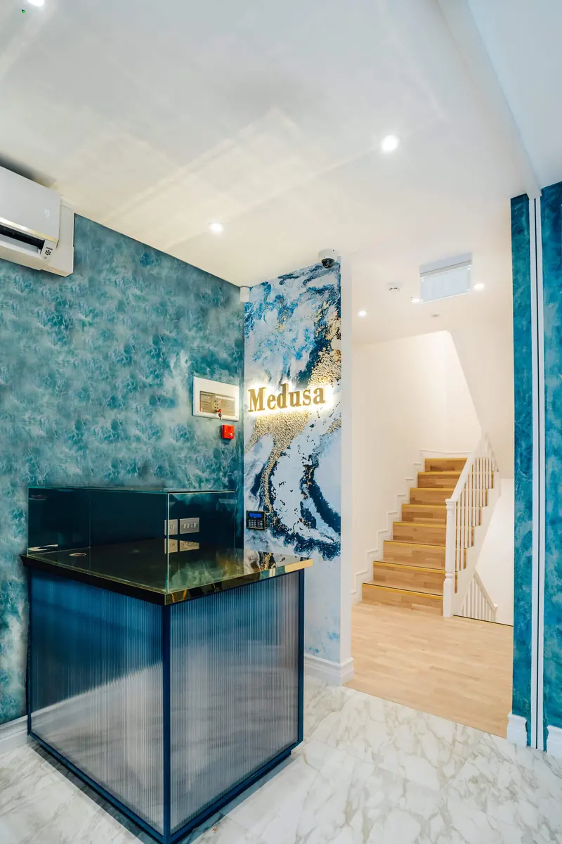 Salon reception desk with a staircase behind