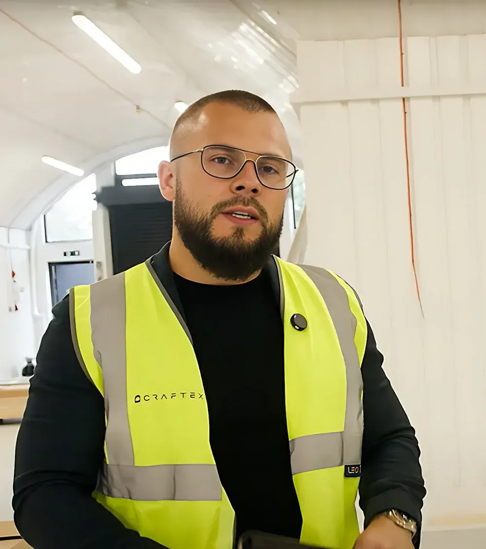 Site manager in a hi-vis vest inside a finished unit