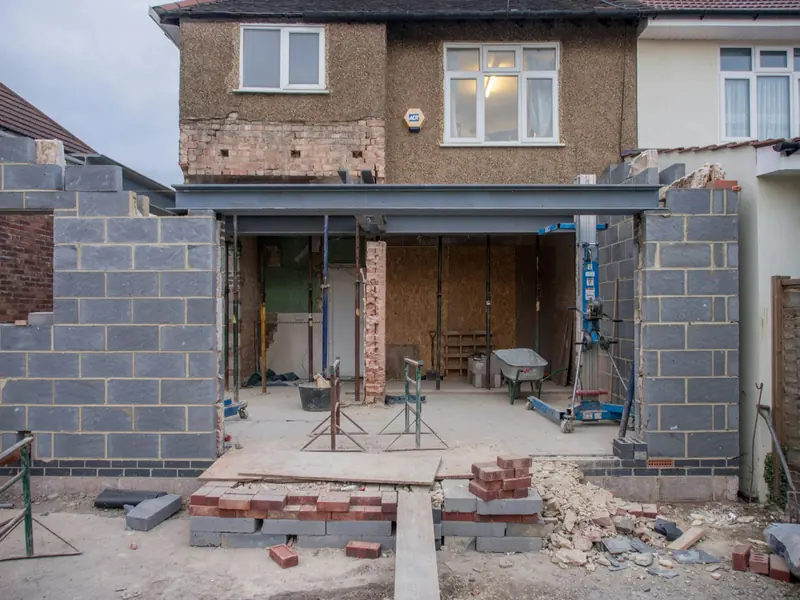 Back of a house opened up for an extension, with steels, blocks and props