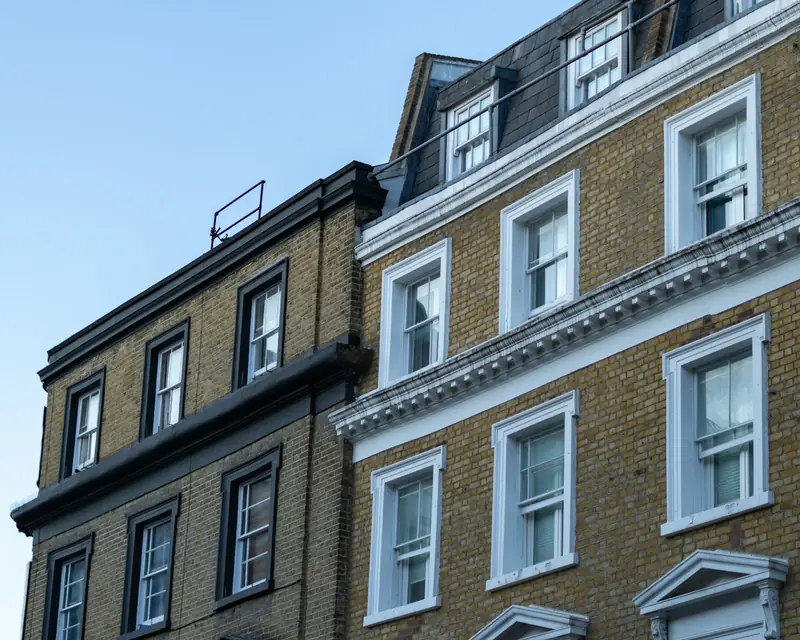 Brick apartment blocks under a blue sky