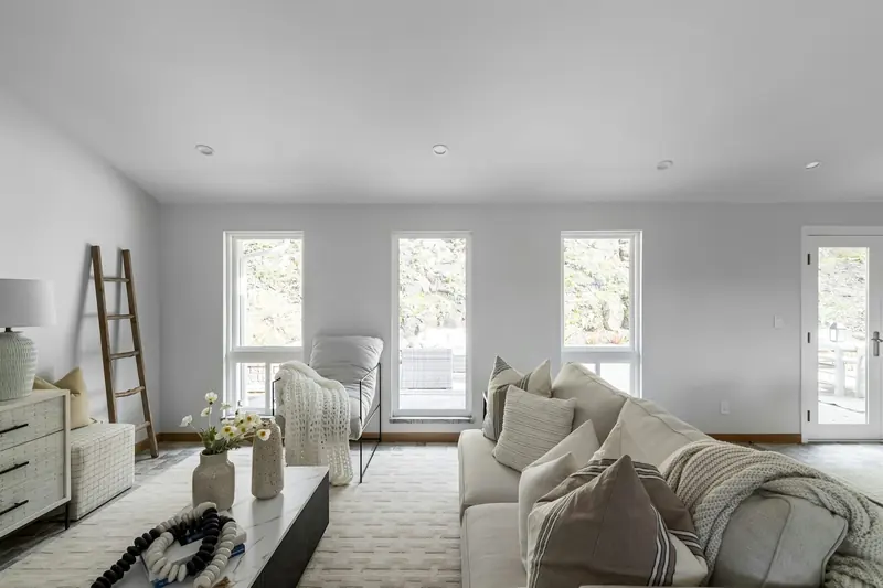 Bright finished living room with white walls and timber floor