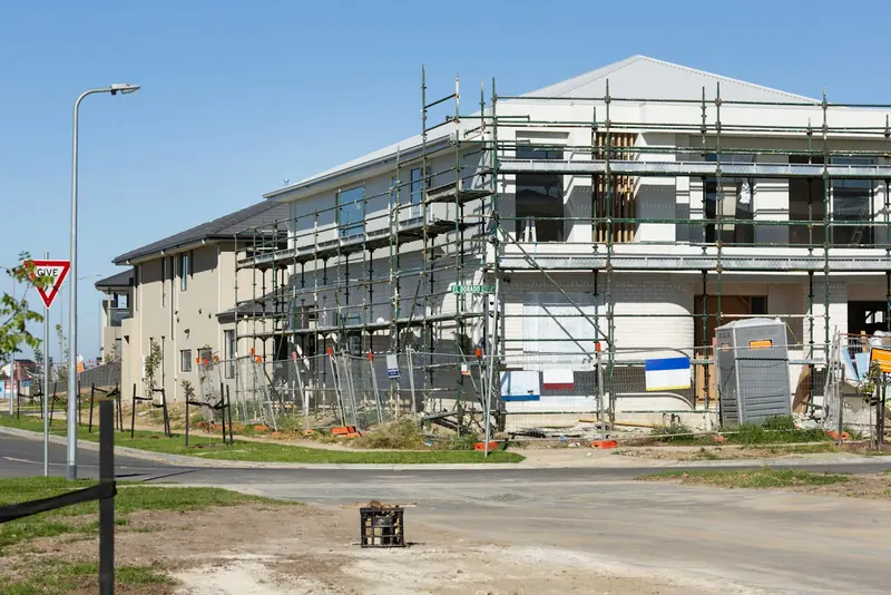 Building under construction wrapped in scaffold