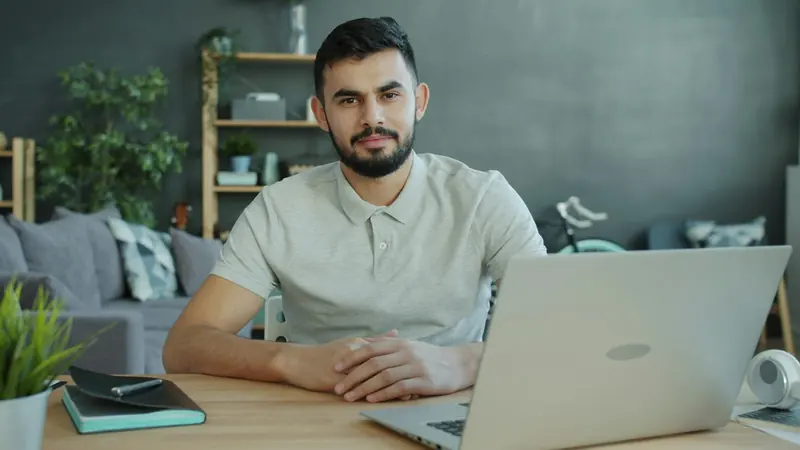 Business owner working at a laptop at his desk
