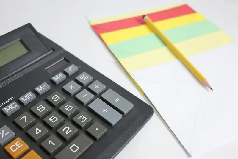 Calculator and pencil on a notepad