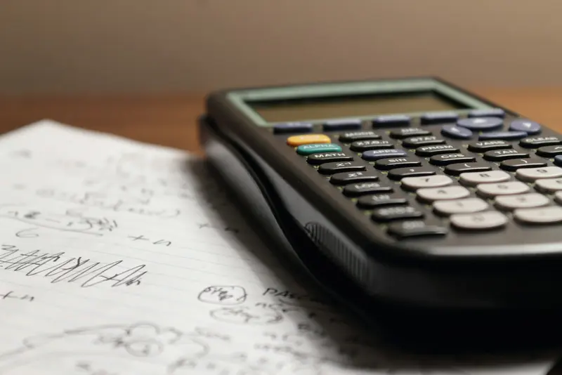 Calculator resting on handwritten workings