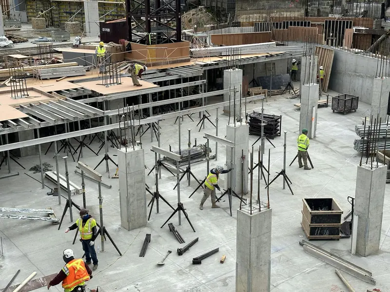 Concrete frame interior with props and operatives on site