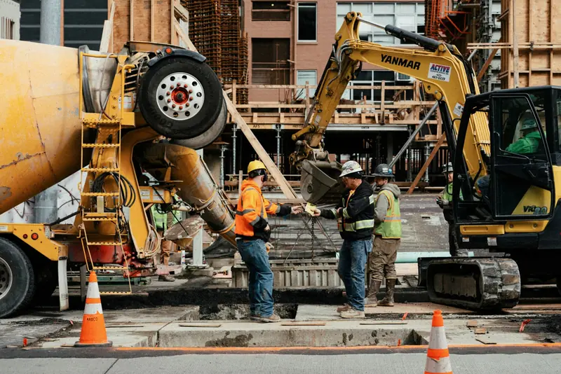 Concrete pour with a mixer lorry and excavator on a building site