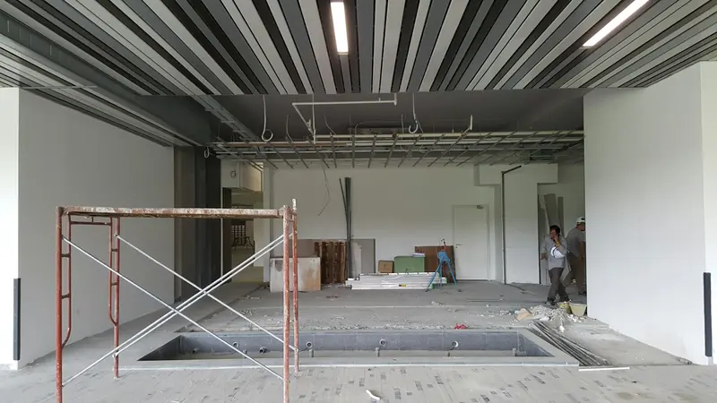Empty commercial shell with a scaffold tower