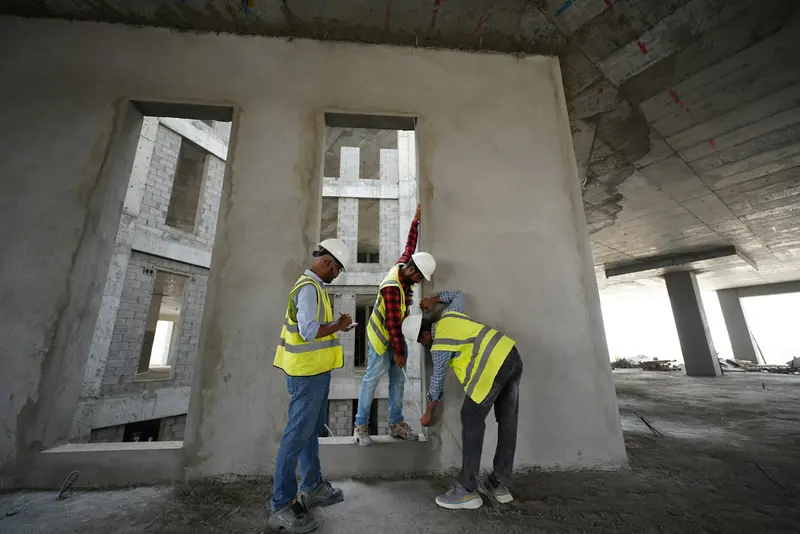 Engineers in hi-vis inspecting a new concrete frame
