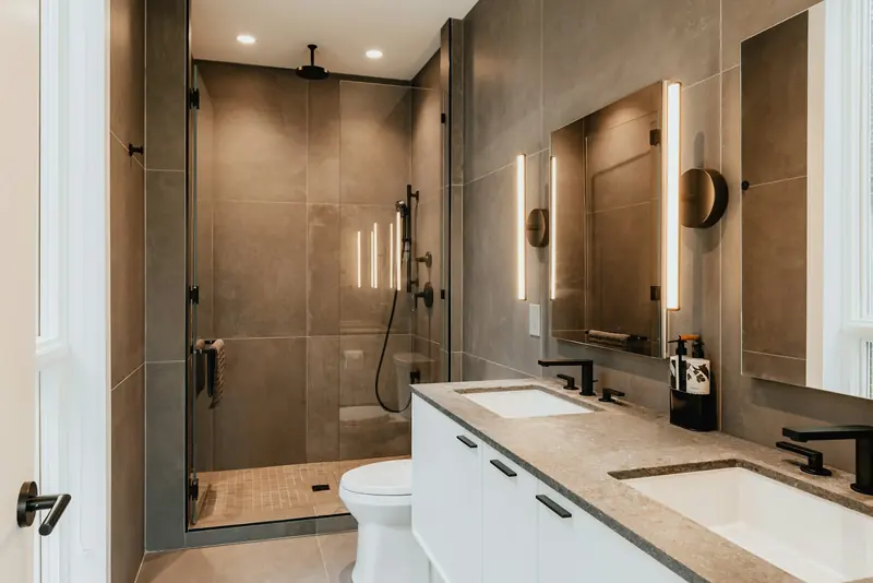 Finished bathroom with twin basins and a tiled shower