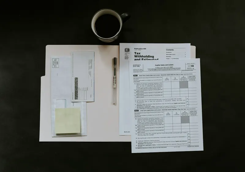 Forms, a pen and a coffee mug on a desk