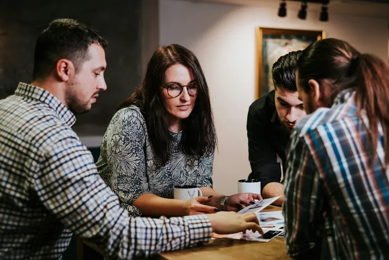 Four people going through documents at a table