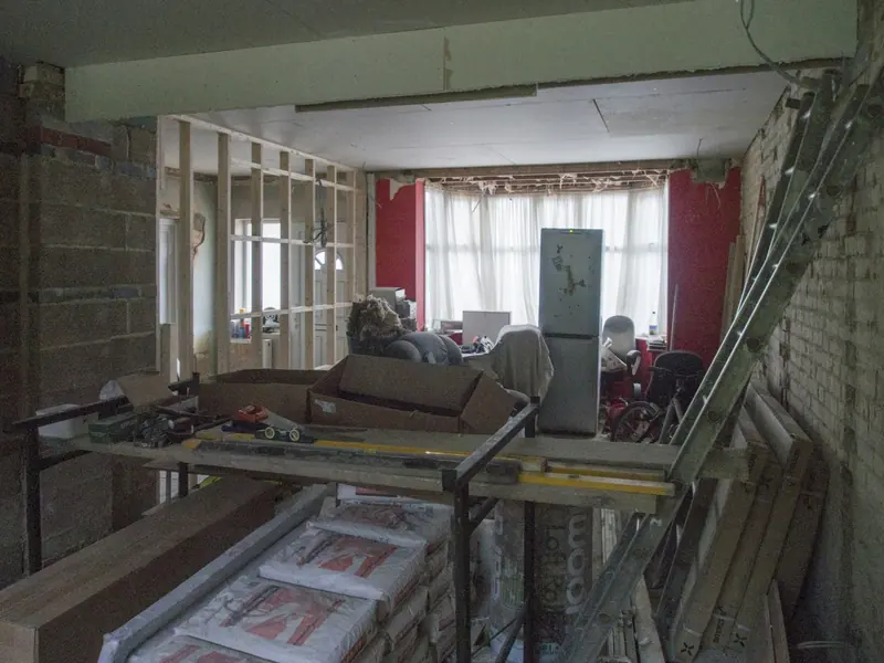 Front room mid-renovation with new stud walls