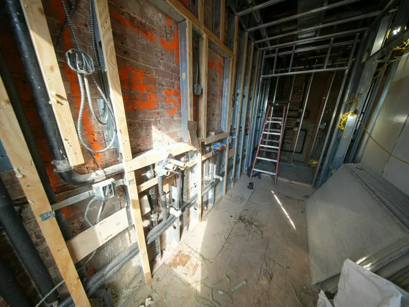Gutted interior with timber stud walls and exposed services