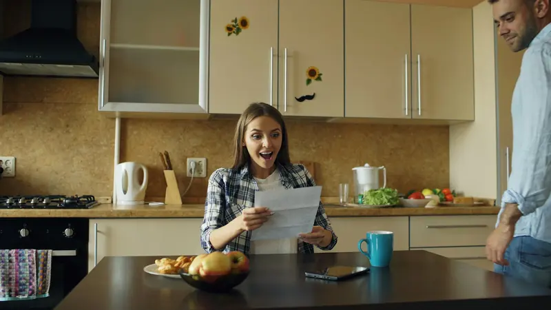 Homeowner reading a letter at the kitchen table