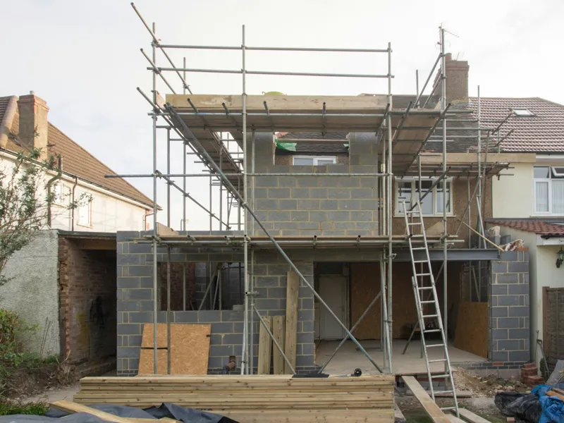House extension in blockwork under scaffold at the back of a semi-detached home