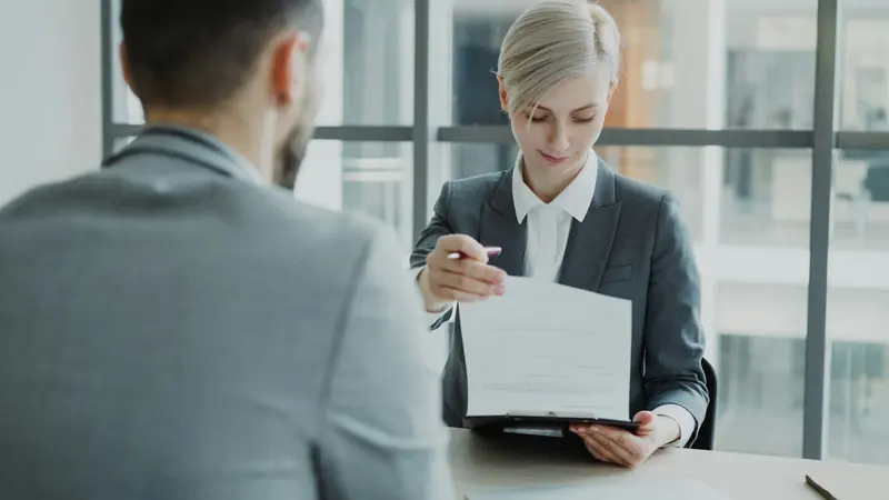 Job interview with a candidate's CV on the table