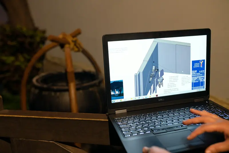 Laptop showing a 3D building model on screen
