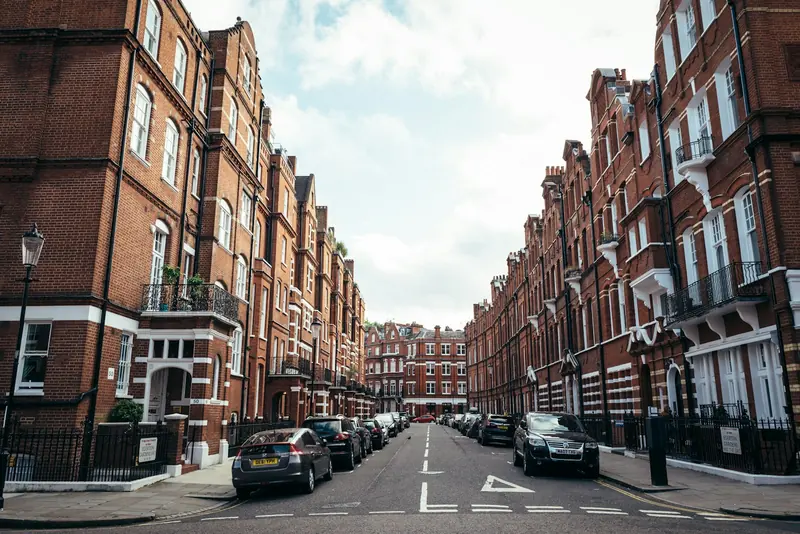 London street lined with red-brick mansion blocks