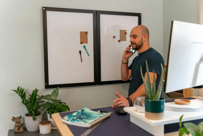 Man on a phone call at a standing desk