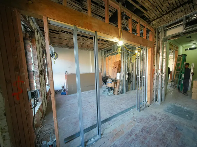 Metal stud partitions going up in a stripped-out commercial unit