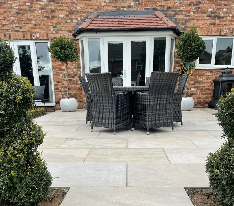 New-build house garden with a paved patio and planting