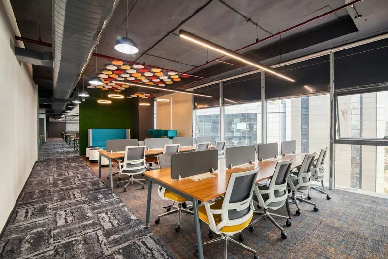 Office with exposed services and timber desks