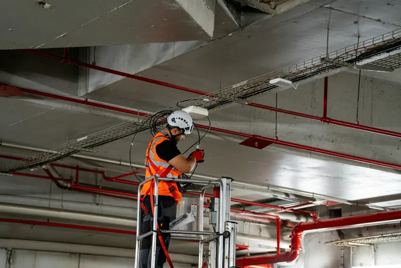 Operative on a lift installing services in a ceiling