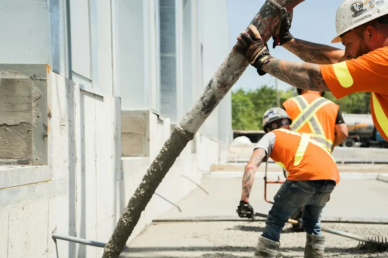 Operatives guiding a concrete pump hose during a pour