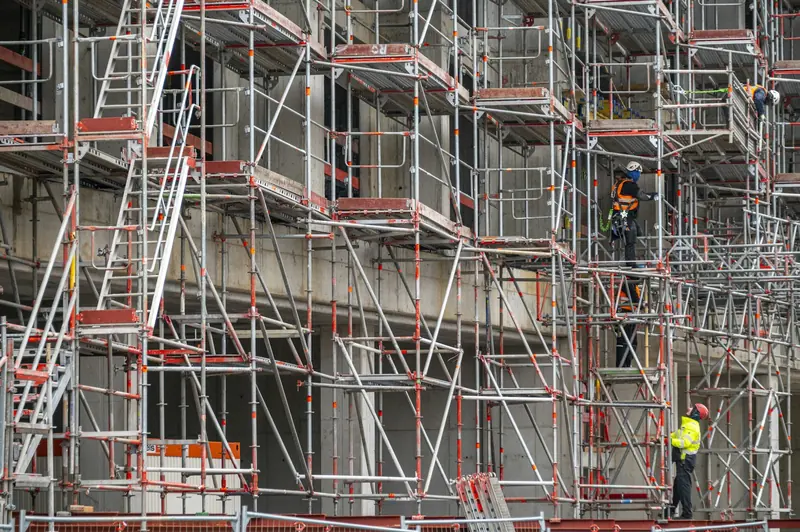 Operatives on a multi-lift scaffold on a building facade