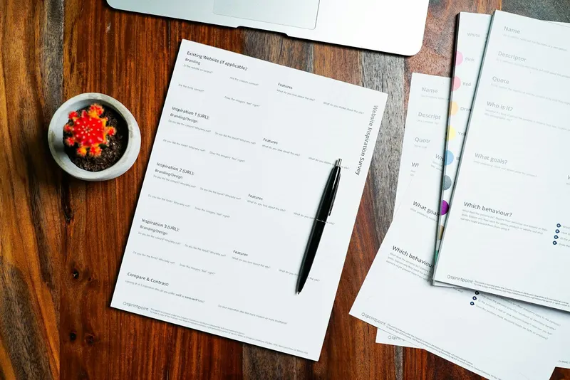 Papers and a pen on a wooden table