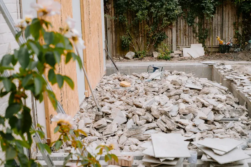 Pile of broken-out rubble in a back garden during building work