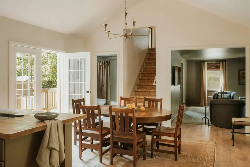 Renovated dining area with timber floor and a staircase