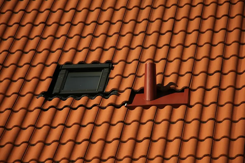 Roof window set into a clay-tiled roof